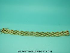 A yellow metal bracelet marked 585, made up of unusual raised links (44.