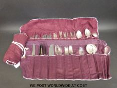 An eight-place setting canteen of cutlery by Elkington and Waring and Gillow in roll out cloth bags