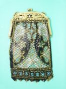 A micro metal mesh purse with gilt metal frame and enamel flower decoration