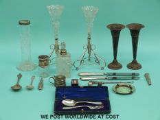 A pair of hallmarked silver trumpet vases (cased), a hallmarked silver spoon and fork set,