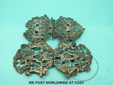 Two hallmarked silver belt buckles one depicting hearts and figures and the other depicting cherubs