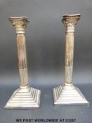 A pair of silver plated Corinthian column candlesticks (height 32cm)