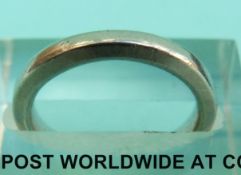 A white metal wedding band marked platinum (Size I, 5.