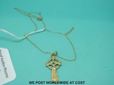 A 9ct gold chain and Celtic cross pendant set with an emerald