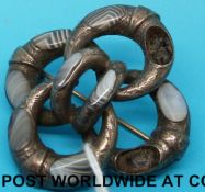 A silver knot brooch set with agate sections and a cameo brooch