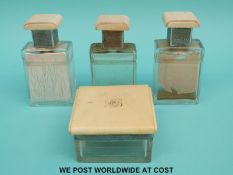 An Art Deco ivory and hallmarked silver mounted cut glass dressing table set comprising three