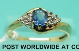 A 9ct gold ring set with a Ceylon sapphire and diamonds (size P/Q)