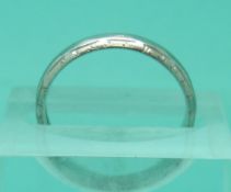 A platinum wedding band with chased floral decoration, 3.