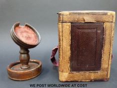 A carriage clock carrying case, together with a turned wooden pocket watch stand,