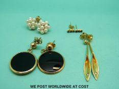 A pair of 18ct gold earrings set with diamonds,