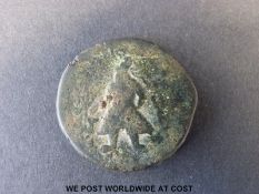 An ancient bronze coin from Pakistan depicting a standing Mogul obverse,