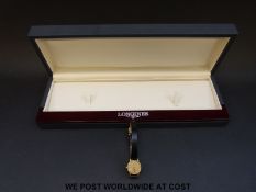 Longines Presence ladies wristwatch with black hands and baton markers, on black leather strap,