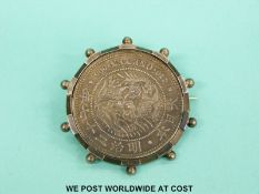 A silver one Yen coin in white metal mount