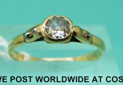 A yellow metal ring set with an old cut diamond of approximately 0.