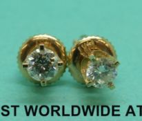 A pair of 14ct gold earrings set with diamonds of approximately 0.