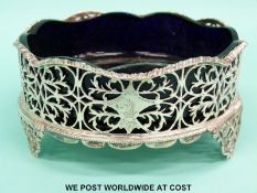 A Georgian hallmarked silver wine coaster or pierced basket with blue glass liner,
