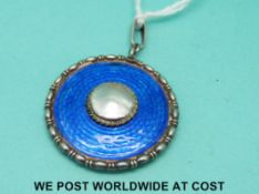 A Charles Horner hallmarked silver circular pendant set with blue guilloche enamel with mother of