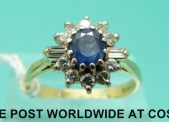 An 18ct gold ring set with an oval sapphire surrounded by round and baguette cut diamonds (size Q)