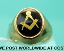 A 9ct gold ring set with onyx decorated with a gold Masonic symbol (Size R,