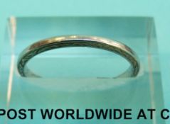 A white metal wedding band marked platinum (Size N, 2.