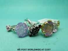 Five silver rings variously set with crackled quartz, pink sapphire, garnets,