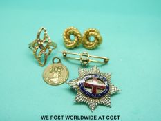 A 9ct gold ring set with a diamond, white metal badge marked 9ct,