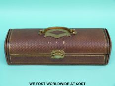 A tooled leather and gilt metal mounted glove box opening to reveal a padded silk interior,