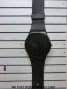 A black Swatch wall watch (26 cm diameter dial)