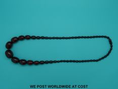 A cherry amber style graduated bead necklace, 74cm long,