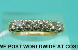 An 18ct gold ring set with seven diamonds (size L)