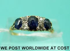 An 18ct gold ring set with sapphires and diamonds (size K)