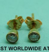 A pair of 18ct gold earrings set with round brilliant cut diamonds of approximately 0.