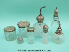 A collection of seven hallmarked silver and white metal mounted atomisers,