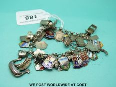 A silver charm bracelet including silver and enamel crests