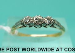 An 18ct gold ring set with three diamonds in a platinum setting (size P)