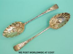 Two Georgian hallmarked silver berry spoons,