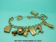 A 9ct gold charm bracelet with eight 9ct and yellow metal charms (28.