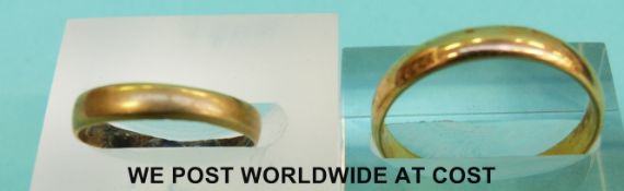 A 22ct gold wedding band (3.9g) and a yellow metal wedding band (1.
