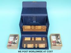 An Asprey bezique set in blue leather-covered case with hallmarked silver clasp,