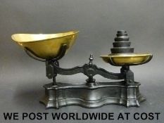 A set of cast iron and brass kitchen or shop scales and weights