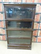 An oak glazed Globe Wernicke four tier bookcase with ivorine plaque to each section (H152 x W87 x