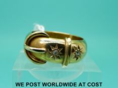 An 18ct gold buckle ring set with two diamonds (size P)
