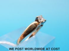 A yellow metal ring marked 14ct set with a round brilliant cut diamond (size I)