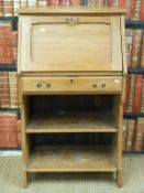 A light oak Art Nouveau students bureau bookcase with single drawer and pierced decoration to the