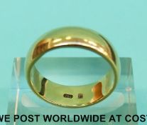 A yellow metal wedding band marked 750 (Size J, 6.