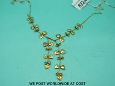 A 15ct gold Art Nouveau necklace set with pearls in heart shapes and peridot