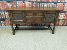 A 19th/20thC carved oak low sideboard or dresser base with two drawers flanked by two cupboards and