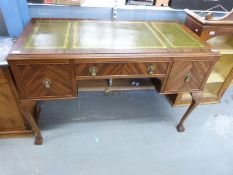 A leather inset mahogany desk with three drawers raised on ball and claw feet (H77 x W121 x D61cm)