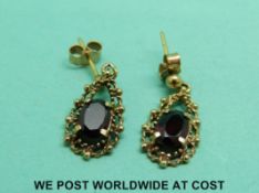 A pair of 9ct gold earrings set with garnets