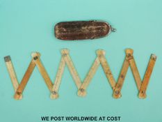 An ivory folding half meter ruler in a leather pouch